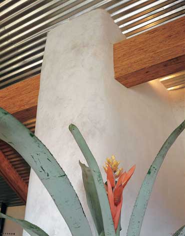 The home’s beautifully handcrafted stone fireplace is a stunning sculptural backdrop for Bennett’s own sculpture, left, and acrylic painting titled, First Mystery, above.